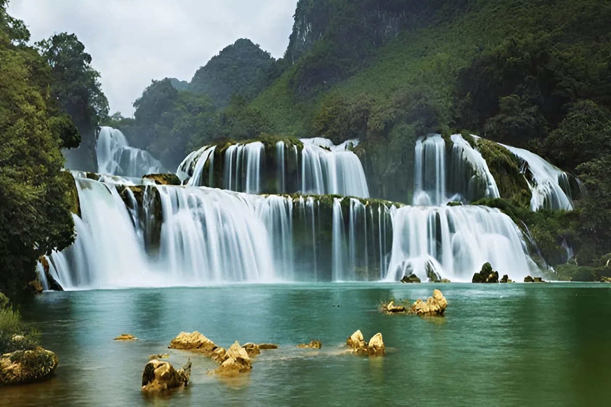 Travelers swimming and relaxing at Du Gia Waterfall on the Ha Giang Loop